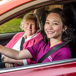 Home Instead Caregiver driving senior woman in car