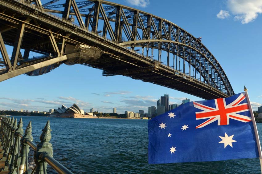 National flag of Australia flies under Sydney Harbour Bridge in Sydney, Australia