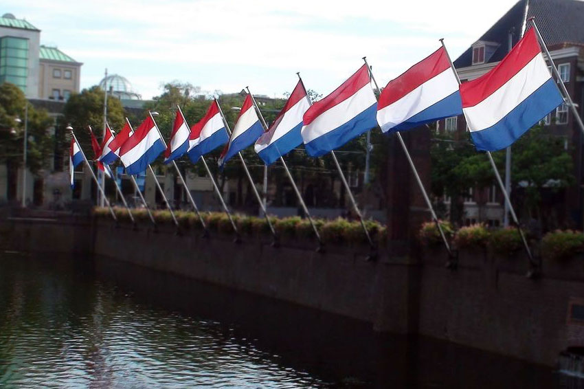 Netherlands flags, water and building exterior scene