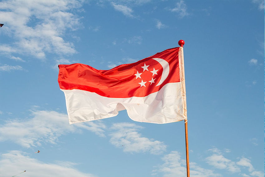 Singaporean flag hanging on a fence