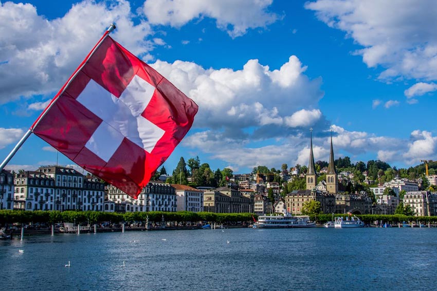 Swiss flag against background of Lake Lucerne